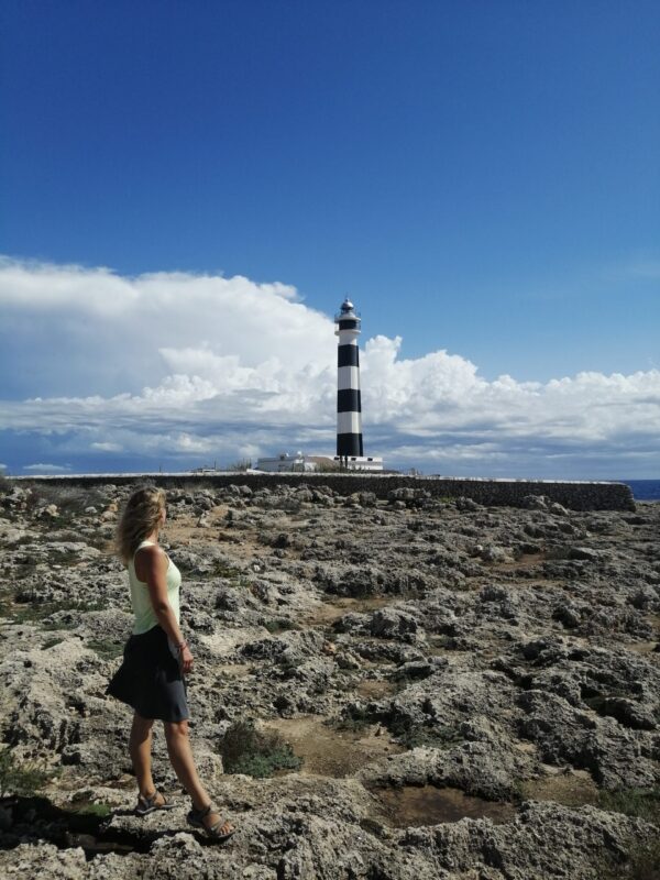 standing near lighthouse in Menorca