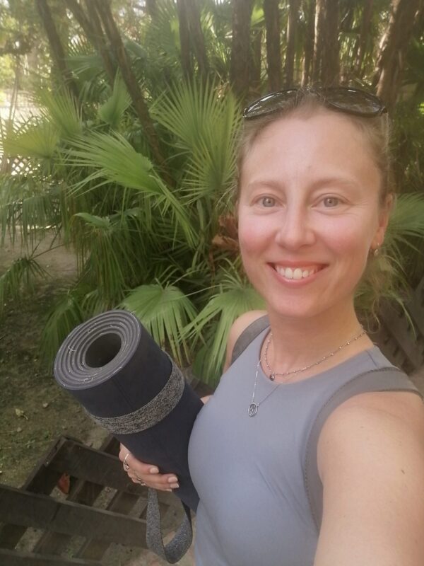 yoga teacher with yoga mat